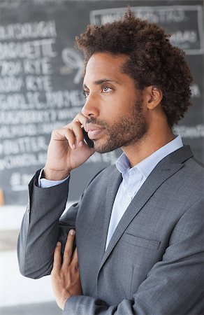 simsearch:400-07139155,k - Handsome businessman on the phone outside at the coffee shop Stock Photo - Budget Royalty-Free & Subscription, Code: 400-07751297