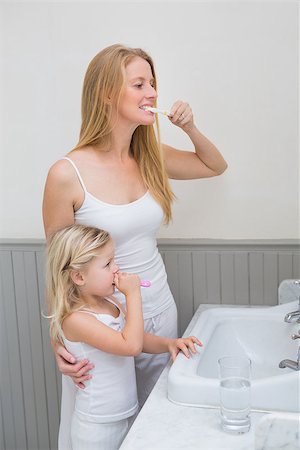 dental mother - Happy mother and daughter brushing their teeth at home in the bathroom Stock Photo - Budget Royalty-Free & Subscription, Code: 400-07751401