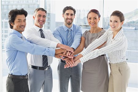 pile hands bussiness - Employee's smiling and having fun while stacking hands together Stock Photo - Budget Royalty-Free & Subscription, Code: 400-07751692