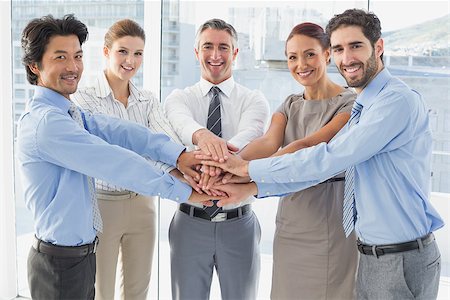 pile hands bussiness - Employee's smiling and having fun while stacking hands together Stock Photo - Budget Royalty-Free & Subscription, Code: 400-07751693