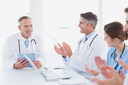 simsearch:640-03257612,k - Doctors applauding a fellow doctor for his research Stock Photo - Budget Royalty-Free & Subscription, Code: 400-07752048