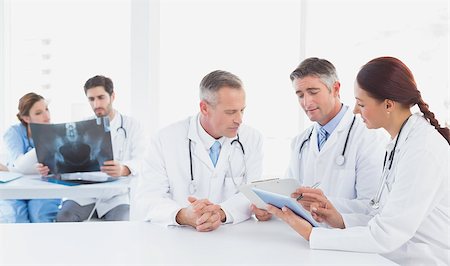 simsearch:400-06799497,k - Doctors sitting together with x-rays and other doctors using a tablet Stockbilder - Microstock & Abonnement, Bildnummer: 400-07752043