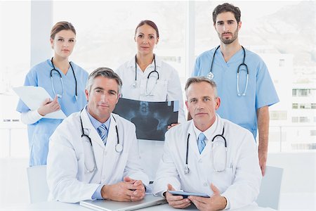 simsearch:400-06799599,k - Doctors looking serious at camera as they work Foto de stock - Super Valor sin royalties y Suscripción, Código: 400-07752065