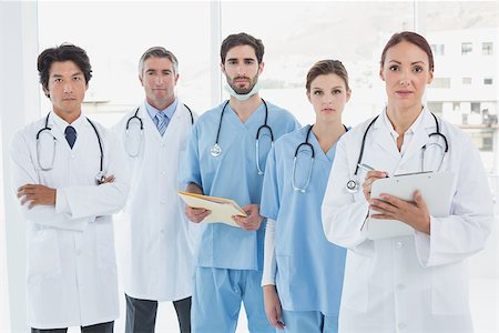 simsearch:400-06799497,k - Serious doctors all standing together and looking at the camera Stockbilder - Microstock & Abonnement, Bildnummer: 400-07752078