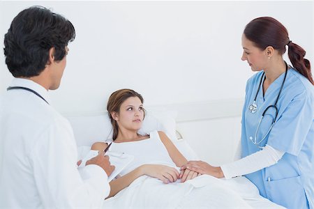 simsearch:685-02938526,k - Doctor looking after his patient with a nurse Stock Photo - Budget Royalty-Free & Subscription, Code: 400-07752099