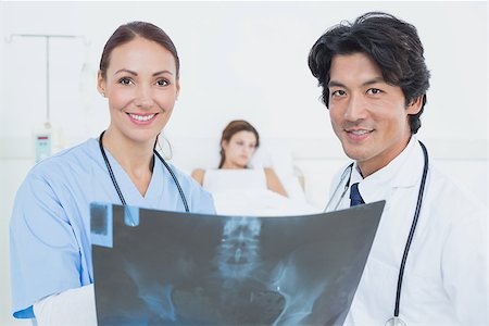 simsearch:685-02938526,k - Nurse and doctor with x-ray looking at the camera Stock Photo - Budget Royalty-Free & Subscription, Code: 400-07752108