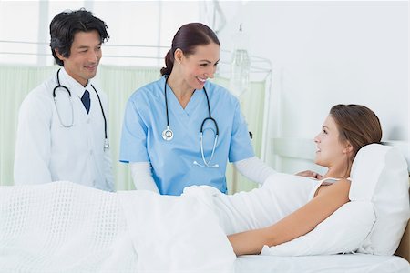 simsearch:400-06734647,k - Nurse and doctor checking patient in her hospital room Stock Photo - Budget Royalty-Free & Subscription, Code: 400-07752110