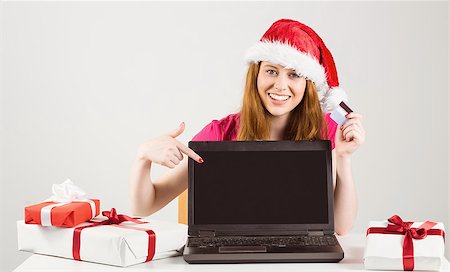 Festive redhead shopping online with laptop on white background Stock Photo - Budget Royalty-Free & Subscription, Code: 400-07752756