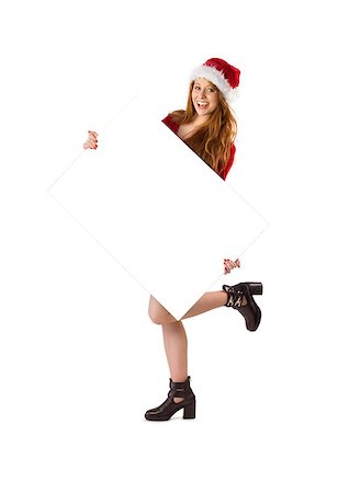 Festive redhead smiling at camera holding poster on white background Stock Photo - Budget Royalty-Free & Subscription, Code: 400-07752821