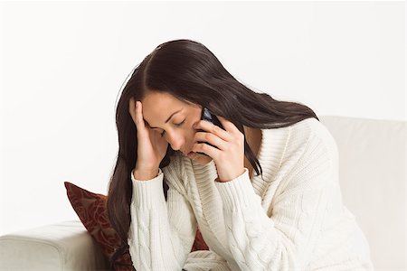 phone with pain - Woman having a bad phone call on white background Stock Photo - Budget Royalty-Free & Subscription, Code: 400-07753017