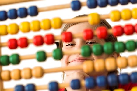 Cute little girl using an abacus on white background Stock Photo - Budget Royalty-Free & Subscription, Code: 400-07753111