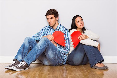 Young couple sitting on floor with broken heart at home Foto de stock - Super Valor sin royalties y Suscripción, Código: 400-07753319