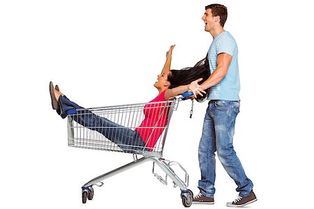 Young couple having fun with shopping cart on white background Stock Photo - Budget Royalty-Free & Subscription, Code: 400-07753346