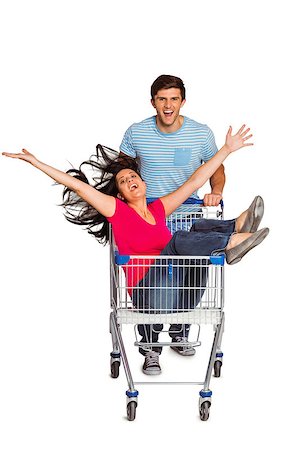 Young couple having fun with shopping cart on white background Stock Photo - Budget Royalty-Free & Subscription, Code: 400-07753348