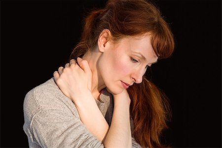 simsearch:400-07778671,k - Scared woman holding herself on black background Fotografie stock - Microstock e Abbonamento, Codice: 400-07753558