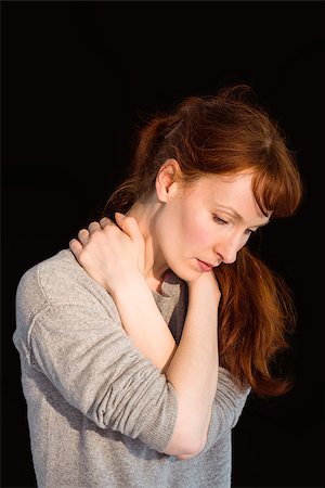 simsearch:400-07833287,k - Scared woman holding herself on black background Fotografie stock - Microstock e Abbonamento, Codice: 400-07753559