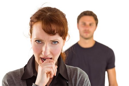 simsearch:400-07833287,k - Worried woman with man behind on white background Fotografie stock - Microstock e Abbonamento, Codice: 400-07753565