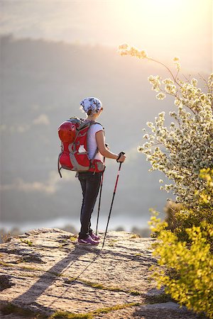 simsearch:400-08186089,k - Young female hiker standing on cliff and enjoying valley view Photographie de stock - Aubaine LD & Abonnement, Code: 400-07769929