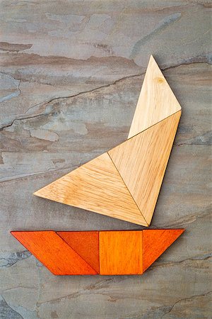 simsearch:400-07774007,k - abstract picture of a sailing yacht built from seven tangram wooden pieces over a slate rock background, artwork created by the photographer Foto de stock - Royalty-Free Super Valor e Assinatura, Número: 400-07774040