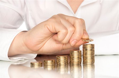 pile hands bussiness - Hand put coins to stack of coins on white background Stock Photo - Budget Royalty-Free & Subscription, Code: 400-07774264