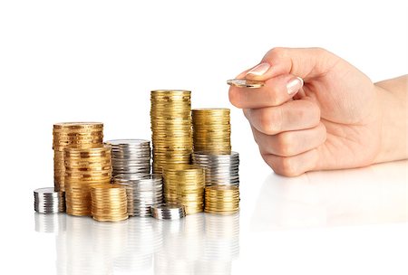 piles of cash pounds - Hand put coins to stack of coins on white background Photographie de stock - Aubaine LD & Abonnement, Code: 400-07774428