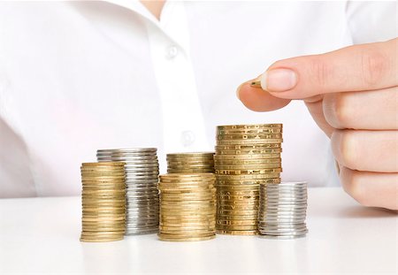 stack of coin sign - Hand put coins to stack of coins on white background Stock Photo - Budget Royalty-Free & Subscription, Code: 400-07774451