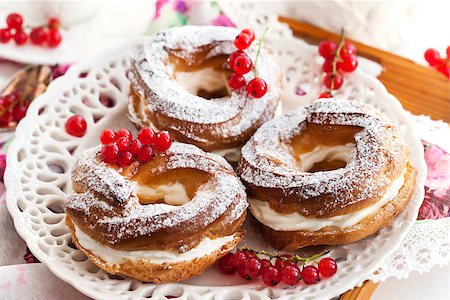 profiterole cake - Cream puff rings (choux pastry) decorated with fresh red currant Stock Photo - Budget Royalty-Free & Subscription, Code: 400-07774644