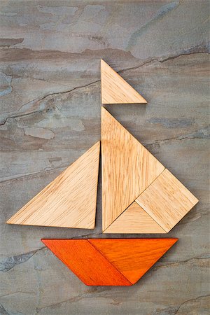 simsearch:400-07774007,k - abstract picture of a sailing boat built from seven tangram wooden pieces over a slate rock background, artwork created by the photographer Foto de stock - Royalty-Free Super Valor e Assinatura, Número: 400-07774684