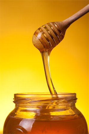 simsearch:400-06640106,k - Close-up shot of wooden dipper with flowing honey over yellow background Stock Photo - Budget Royalty-Free & Subscription, Code: 400-07776244