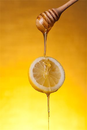 simsearch:400-06640106,k - Honey flowing on lemon slice, studio shot over yellow background Stock Photo - Budget Royalty-Free & Subscription, Code: 400-07776246