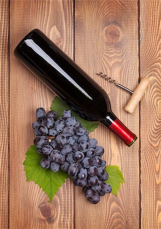simsearch:400-08110621,k - Red wine bottle and bunch of red grapes on wooden table background Stock Photo - Budget Royalty-Free & Subscription, Code: 400-07776977
