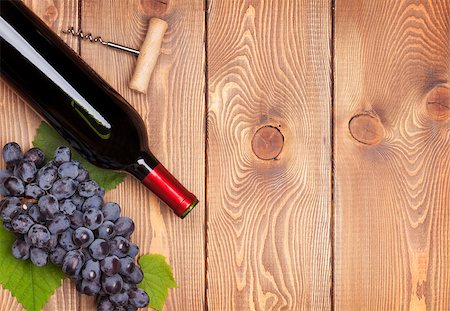 simsearch:400-08110621,k - Red wine bottle and bunch of red grapes on wooden table background with copy space Stock Photo - Budget Royalty-Free & Subscription, Code: 400-07776978