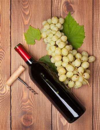 simsearch:400-08110621,k - Red wine bottle and bunch of white grapes on wooden table background Stock Photo - Budget Royalty-Free & Subscription, Code: 400-07776979