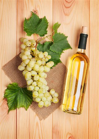 simsearch:400-08110621,k - White wine bottle and bunch of white grapes on wooden table background Stock Photo - Budget Royalty-Free & Subscription, Code: 400-07776985