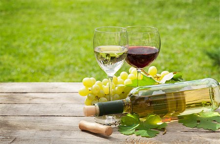 White and red wine glasses and bottle with bunch of grapes in sunny garden Stock Photo - Budget Royalty-Free & Subscription, Code: 400-07776982