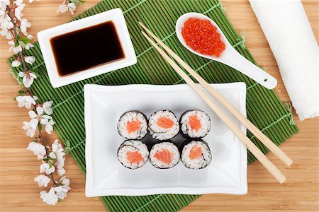 simsearch:400-08072780,k - Red caviar, sushi set, sakura branch and chopsticks over bamboo table Photographie de stock - Aubaine LD & Abonnement, Code: 400-07777055