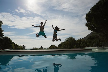 swimming pool full - Full length of a cheerful young couple jumping into swimming pool Stock Photo - Budget Royalty-Free & Subscription, Code: 400-07777384