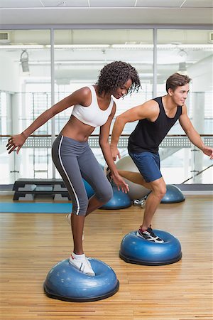 simsearch:400-07777565,k - Couple doing aerobics on bosu balls at the gym Stockbilder - Microstock & Abonnement, Bildnummer: 400-07777546