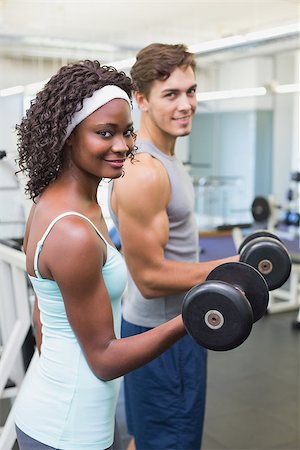 simsearch:400-07777565,k - Fit couple lifting dumbbells together at the gym Stockbilder - Microstock & Abonnement, Bildnummer: 400-07777607