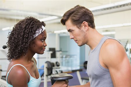 simsearch:400-07777565,k - Fit couple lifting dumbbells together at the gym Stockbilder - Microstock & Abonnement, Bildnummer: 400-07777610