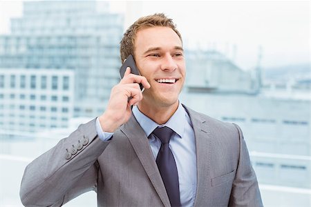 simsearch:400-07139155,k - Smart young businessman using mobile phone in office Stock Photo - Budget Royalty-Free & Subscription, Code: 400-07777753