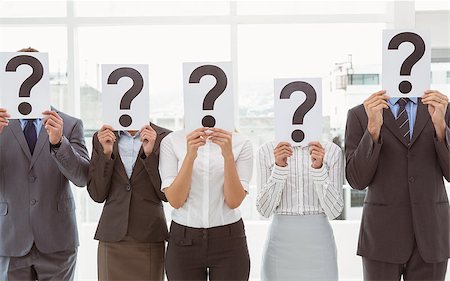 question mark - Business people holding question mark signs in front of their faces in office Stock Photo - Budget Royalty-Free & Subscription, Code: 400-07777884