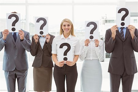 Business people holding question mark signs in front of their faces in office Stock Photo - Budget Royalty-Free & Subscription, Code: 400-07777885