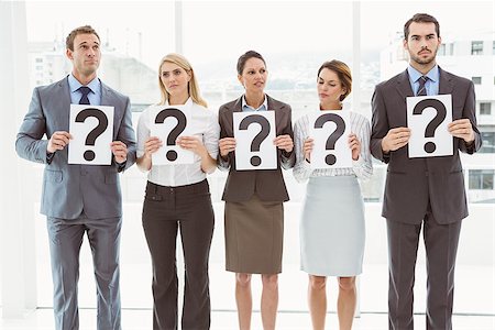 Business people holding question mark signs in office Stock Photo - Budget Royalty-Free & Subscription, Code: 400-07777886