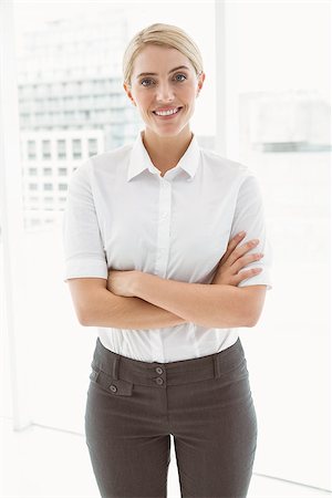 simsearch:400-07275828,k - Portrait of beautiful young businesswoman with arms crossed in office Photographie de stock - Aubaine LD & Abonnement, Code: 400-07777946