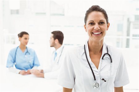 simsearch:400-07778150,k - Portrait of a smiling confident female doctor at medical office Stock Photo - Budget Royalty-Free & Subscription, Code: 400-07778134