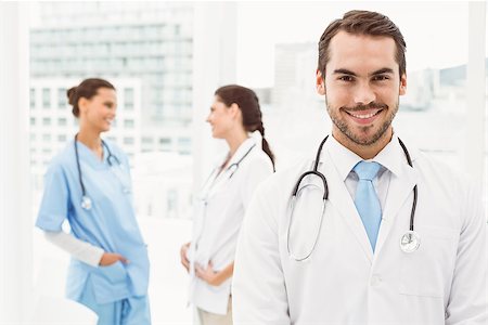 simsearch:400-07778150,k - Portrait of a smiling confident male doctor at medical office Stock Photo - Budget Royalty-Free & Subscription, Code: 400-07778131