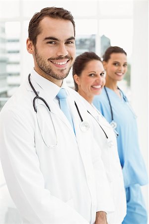 simsearch:400-07778150,k - Smiling confident doctors standing at medical office Stock Photo - Budget Royalty-Free & Subscription, Code: 400-07778133