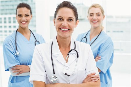 simsearch:400-07778150,k - Portrait of confident female doctors with arms crossed at medical office Stock Photo - Budget Royalty-Free & Subscription, Code: 400-07778163