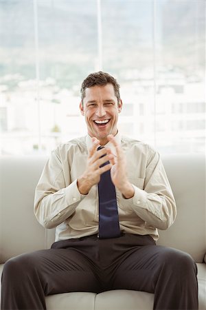 sophisticated home smile - Portrait of happy young businessman sitting on couch in living room Stock Photo - Budget Royalty-Free & Subscription, Code: 400-07778395